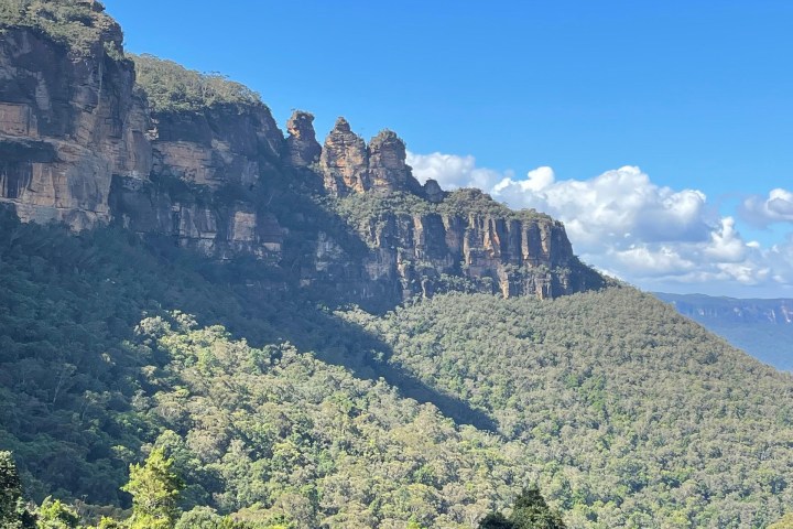 Scenic view of forested mountains under a clear blue sky.